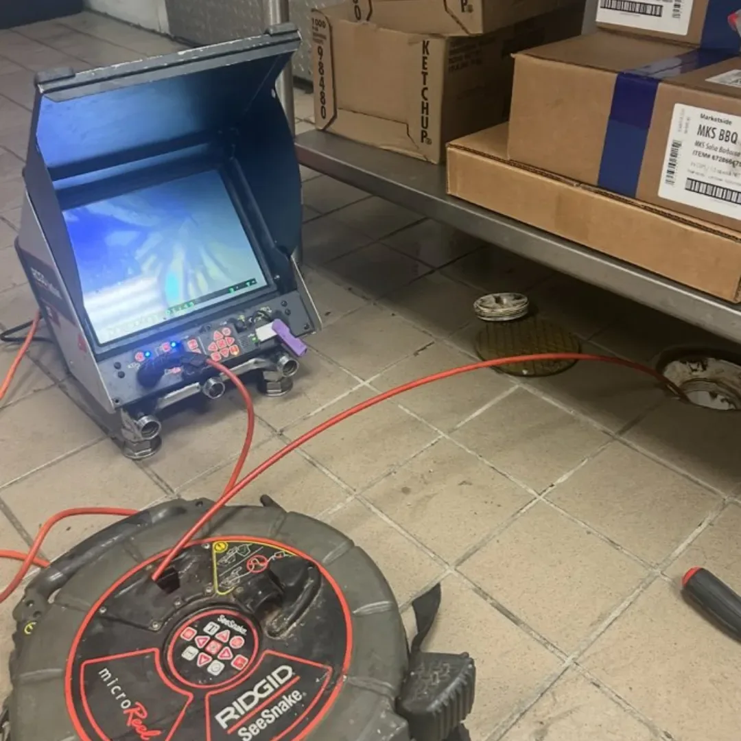 Sewer camera reel and monitor set up on a commercial kitchen drain job