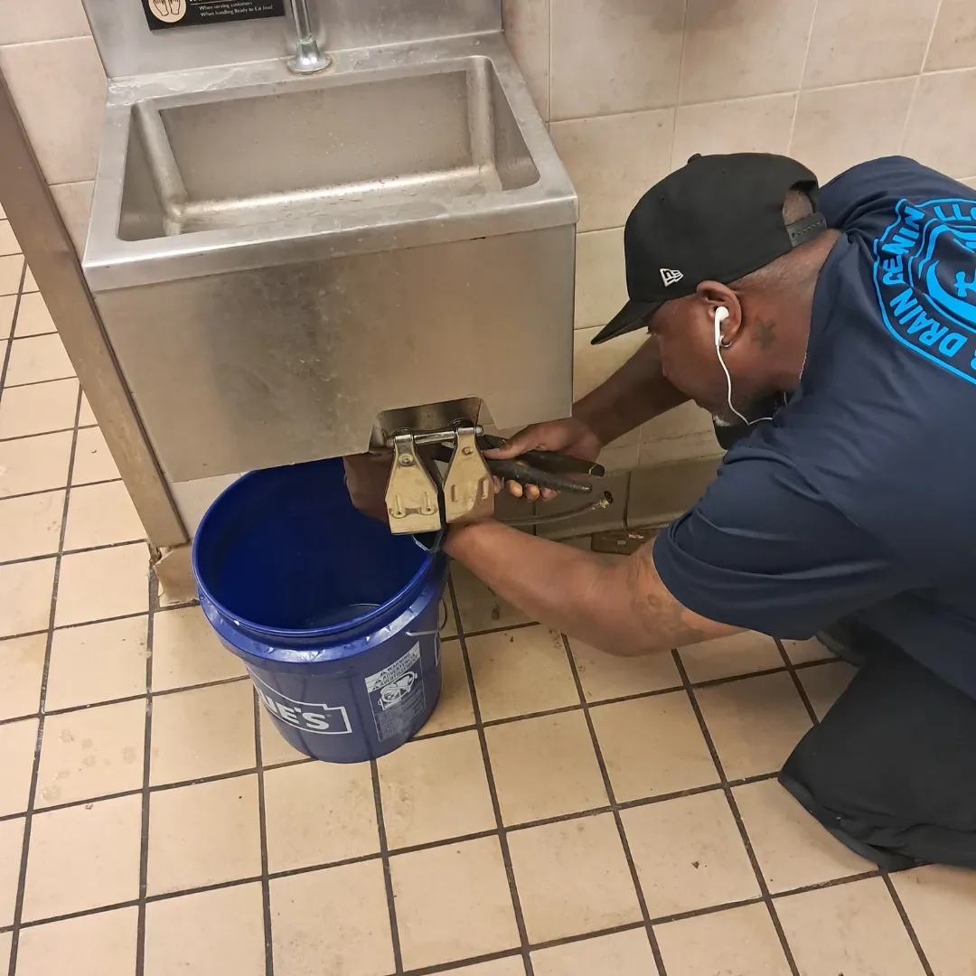 D3 Drain Cleaning technician clearing a drain at a commercial hand sink